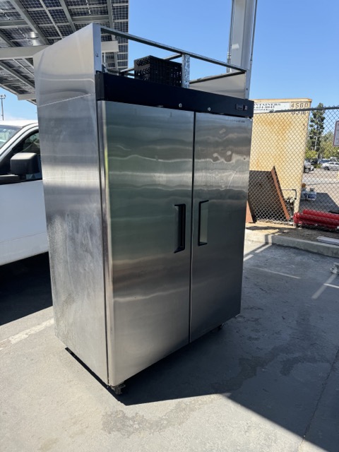 Stainless two-door commercial refrigerator on casters ready for pickup