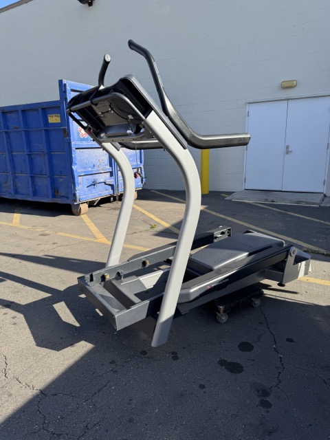 Commercial treadmill staged in a lot for bulky fitness-equipment removal